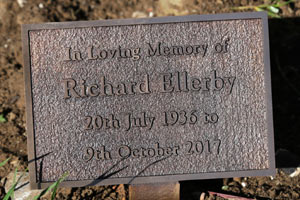Small cast bronze memorial on a stake. Small cast bronze memorial on a stake.
