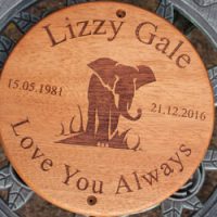 Lovely round wooden memorial plaque.
