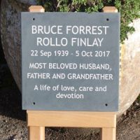 Slate memorial on wooden posts.