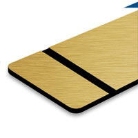 Brushed gold surface with black lettering. Brushed gold surface with black lettering.