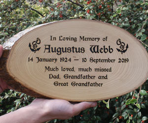 Rustic wooden memorial plaque.