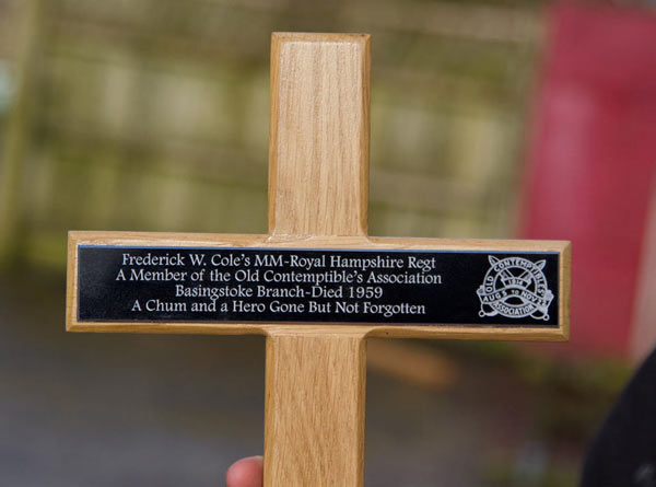 Black anodised aluminium plaque on an oak cross. Black anodised aluminium plaque on an oak cross.