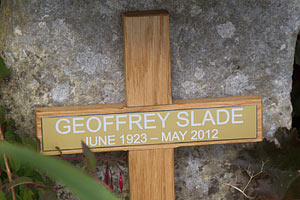 Gold plaque on oak cross. Gold plaque on oak cross.
