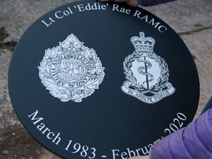 Round slate sign with laser etched crests. Round slate sign with laser etched crests.