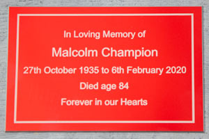 Red anodised aluminium memorial plaque. Red anodised aluminium memorial plaque.