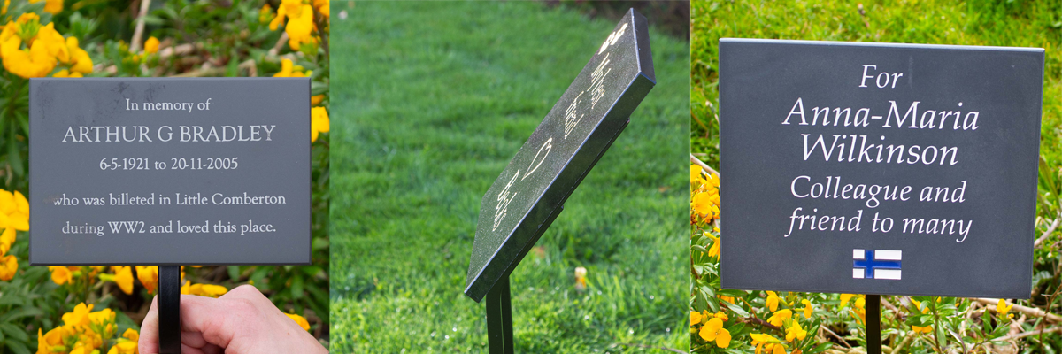 Slate and granite memorials on stakes.