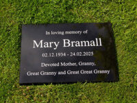Granite memorial with white letters.